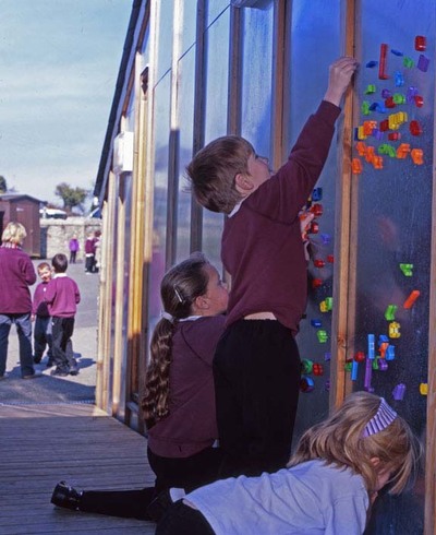 Children playing with the magnetics in the access corridor