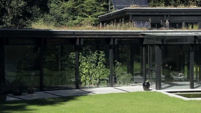 Glazed sun space with house plants and lawn